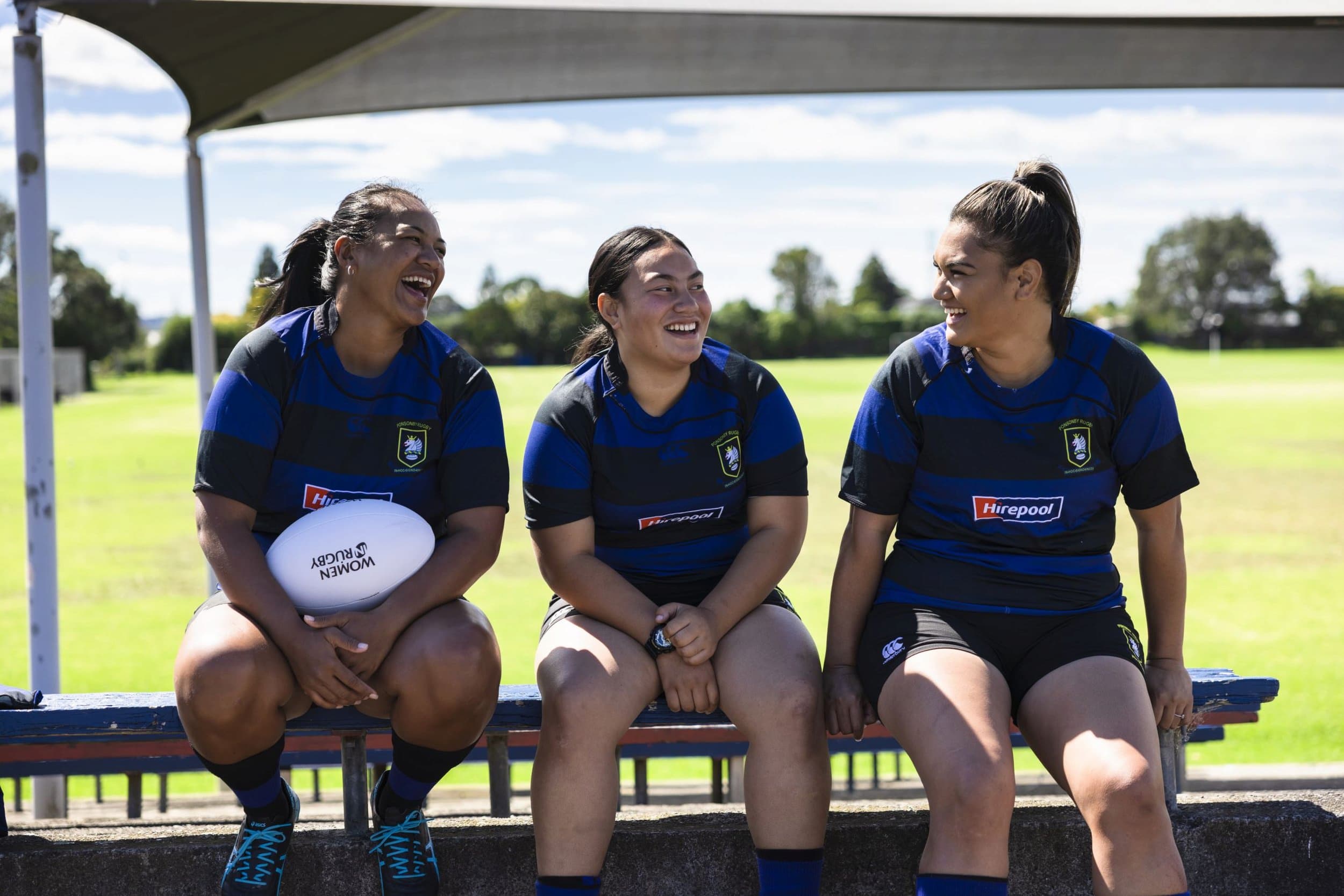 Three Rugby players laughing
